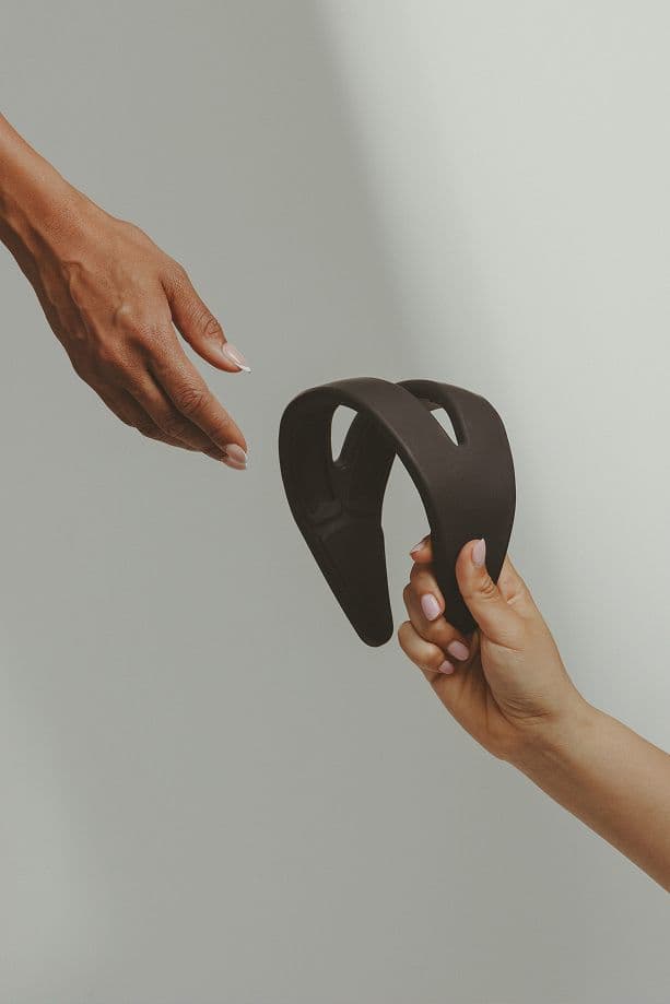 Hands reaching to connect over a Samphire device