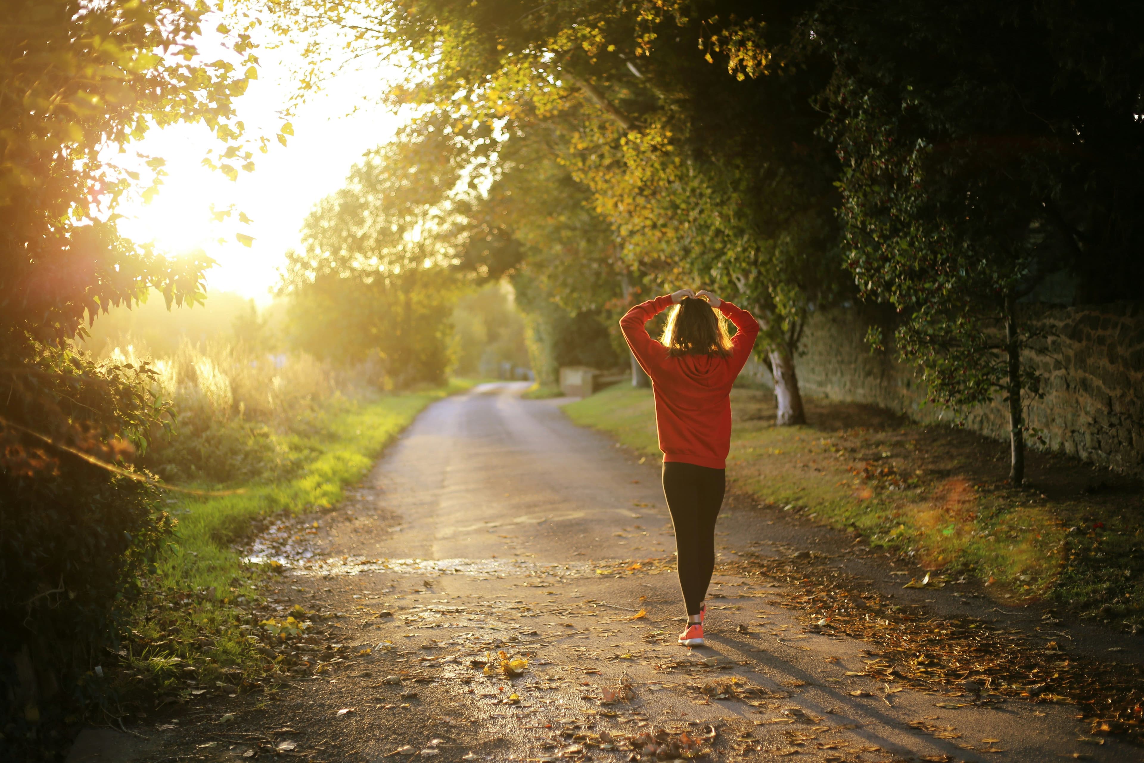 Woman walking through woodland