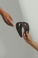 Hands reaching to connect over a Samphire device